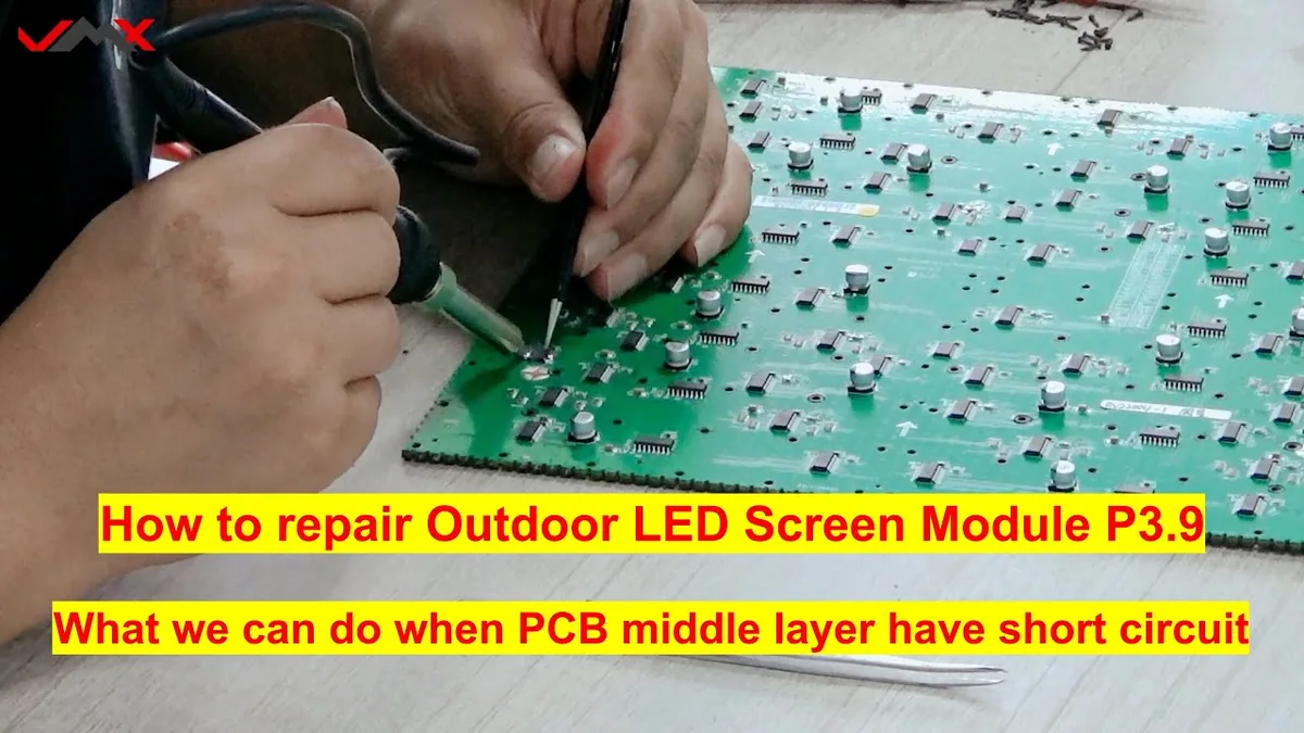 Technician working on the rear PCB of an outdoor LED module during a short-circuit repair demonstration